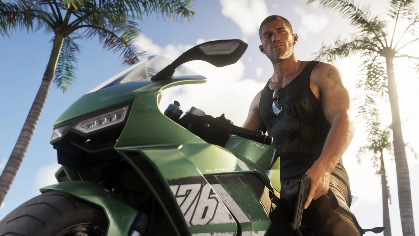 Jason stands beside a green sport motorcycle under palm trees.
