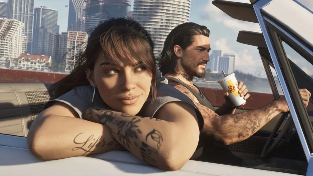 Lucia leans from a convertible while Jason drives through the city.
